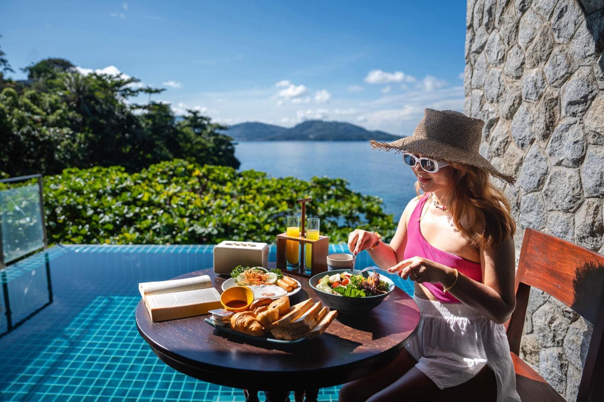 Zenmaya Oceanfront Phuket, Trademark Collection By Wyndham Patong Kültér fotó A woman eating breakfast at a resort